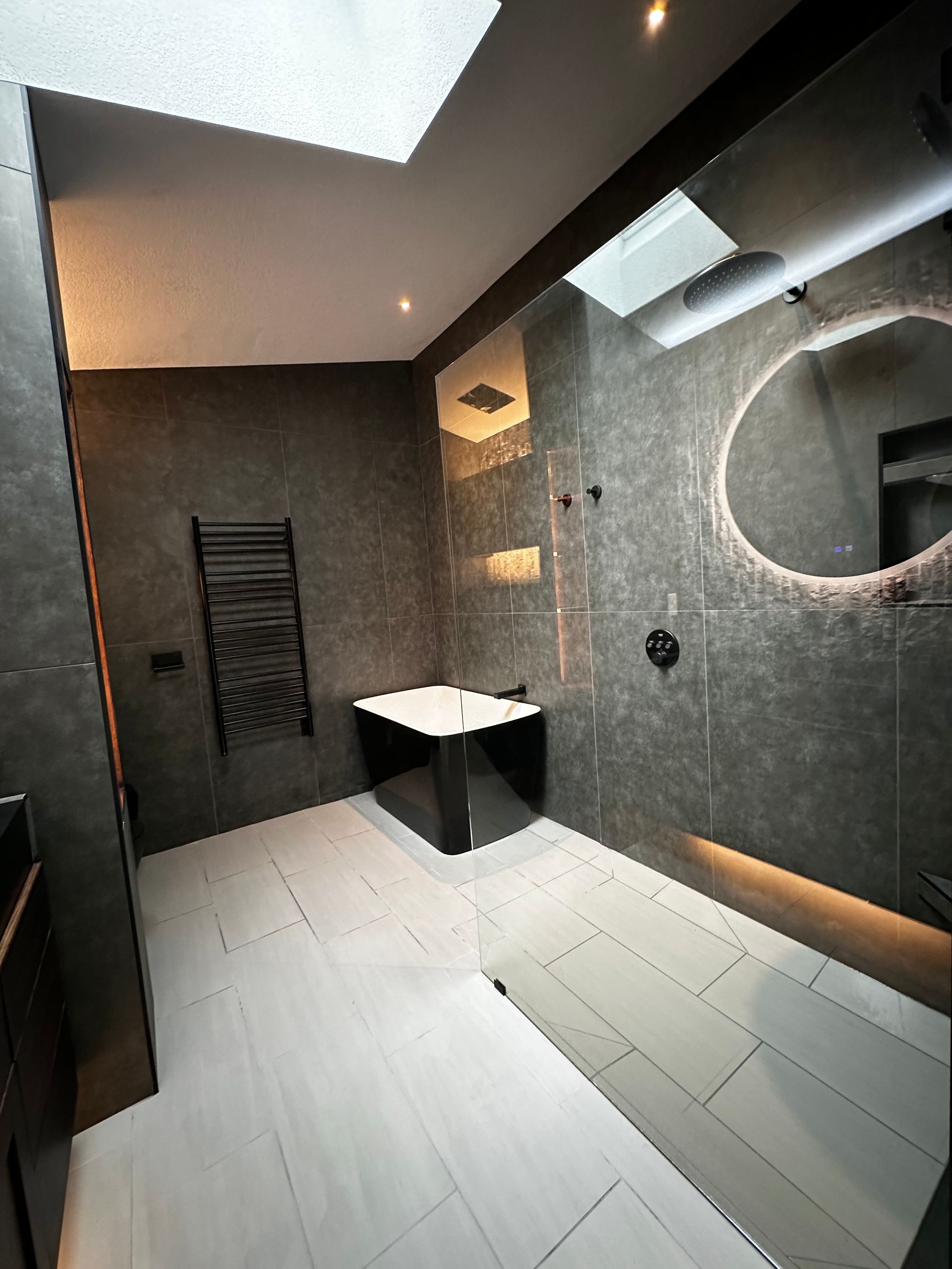 A bathroom with a bathtub and a large mirror