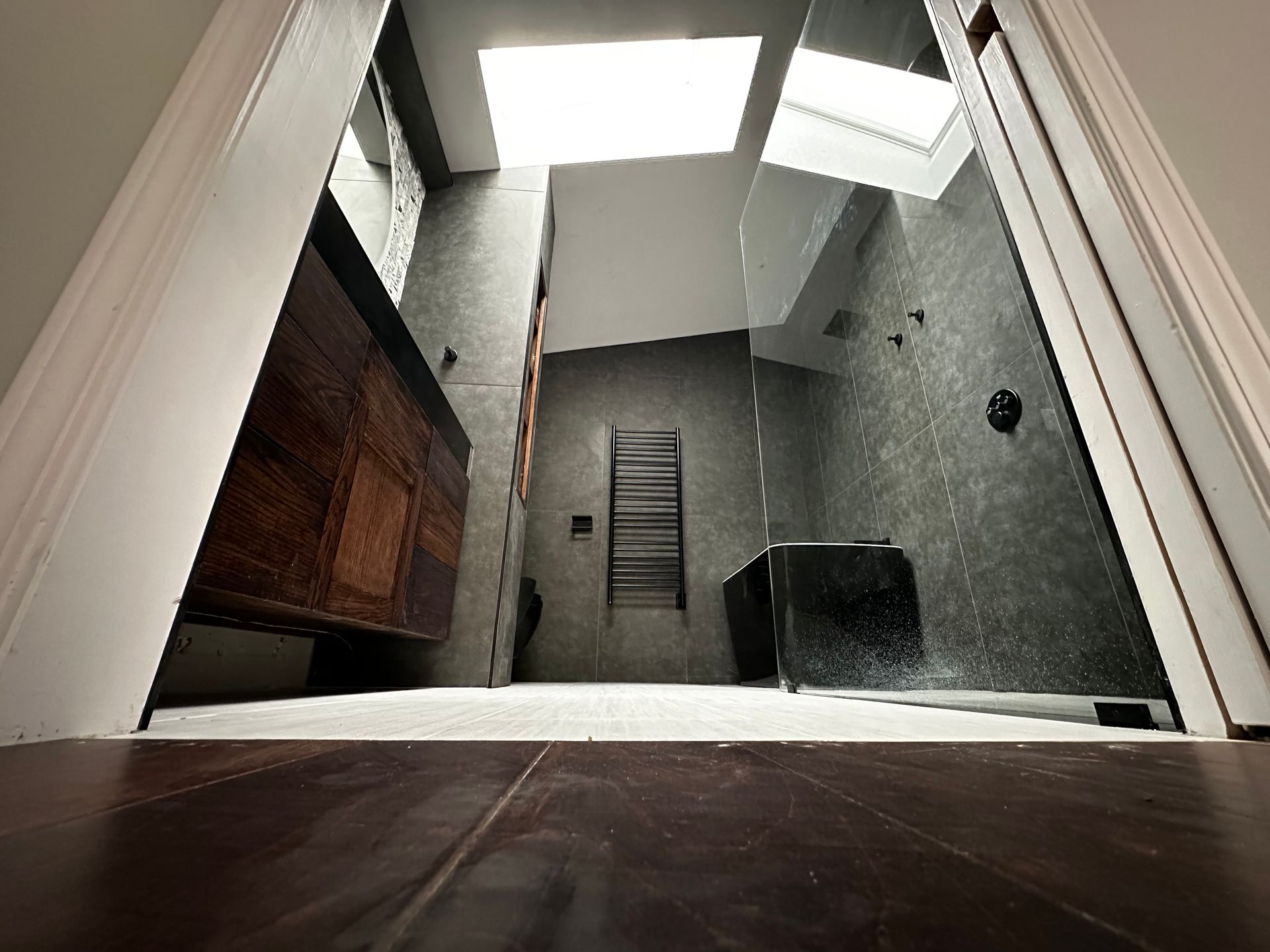 Looking up at a bathroom with a skylight in the ceiling