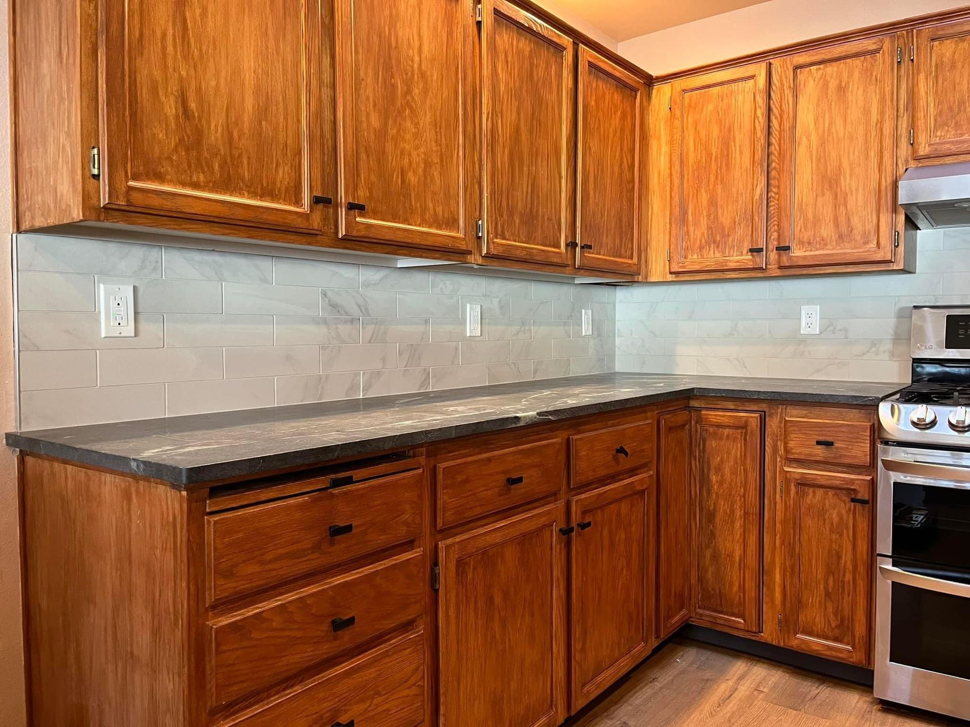A kitchen with wooden cabinets and stainless steel appliances.