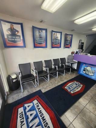 AAMCO Lake Forest's interior, showing the front counter with a waiting area