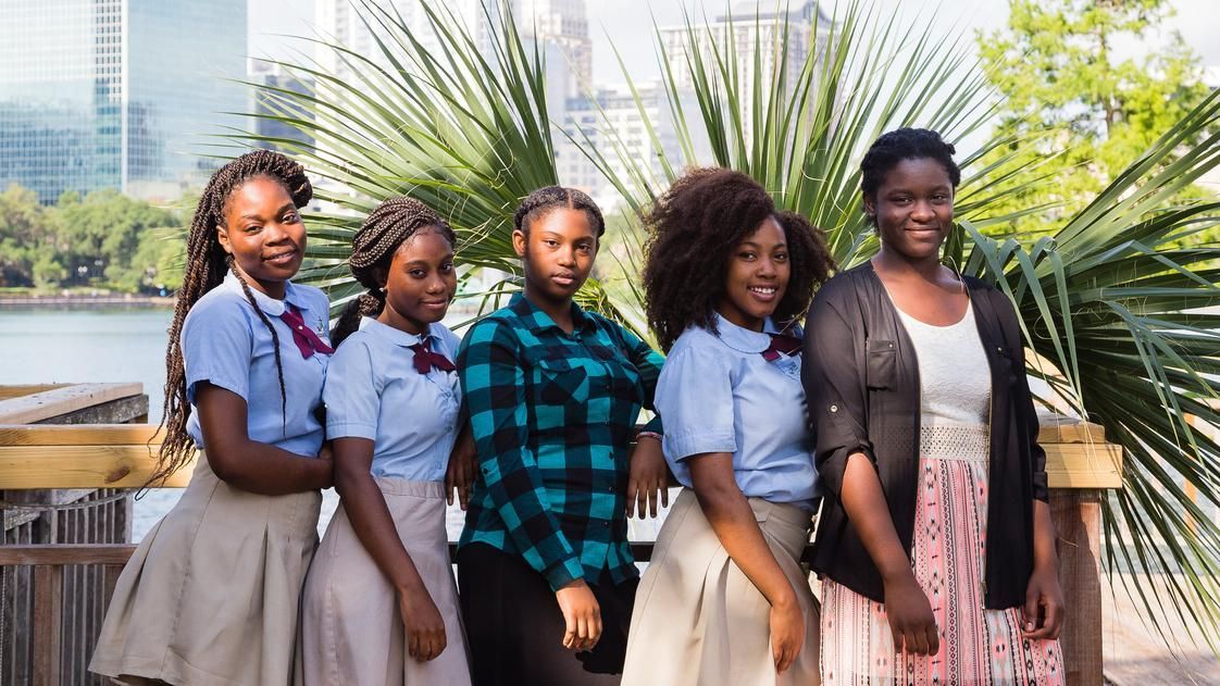 A group of young women are posing for a picture together.