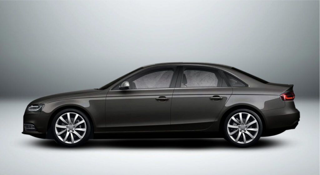 Um audi a4 preto está sentado em uma superfície branca.