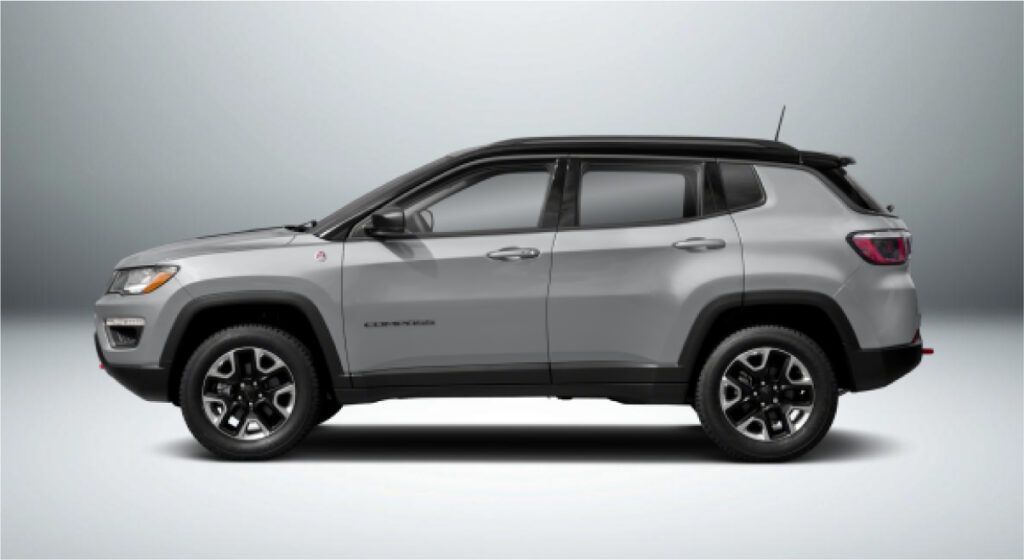 Uma bússola de jipe ​​prateada com teto preto sobre fundo branco.