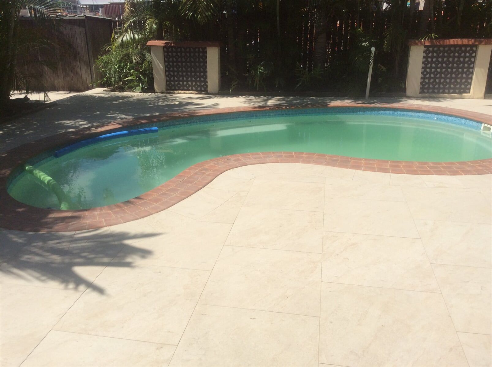 Large Green Swimming Pool With A Brick Border — Paving in Darwin River, NT