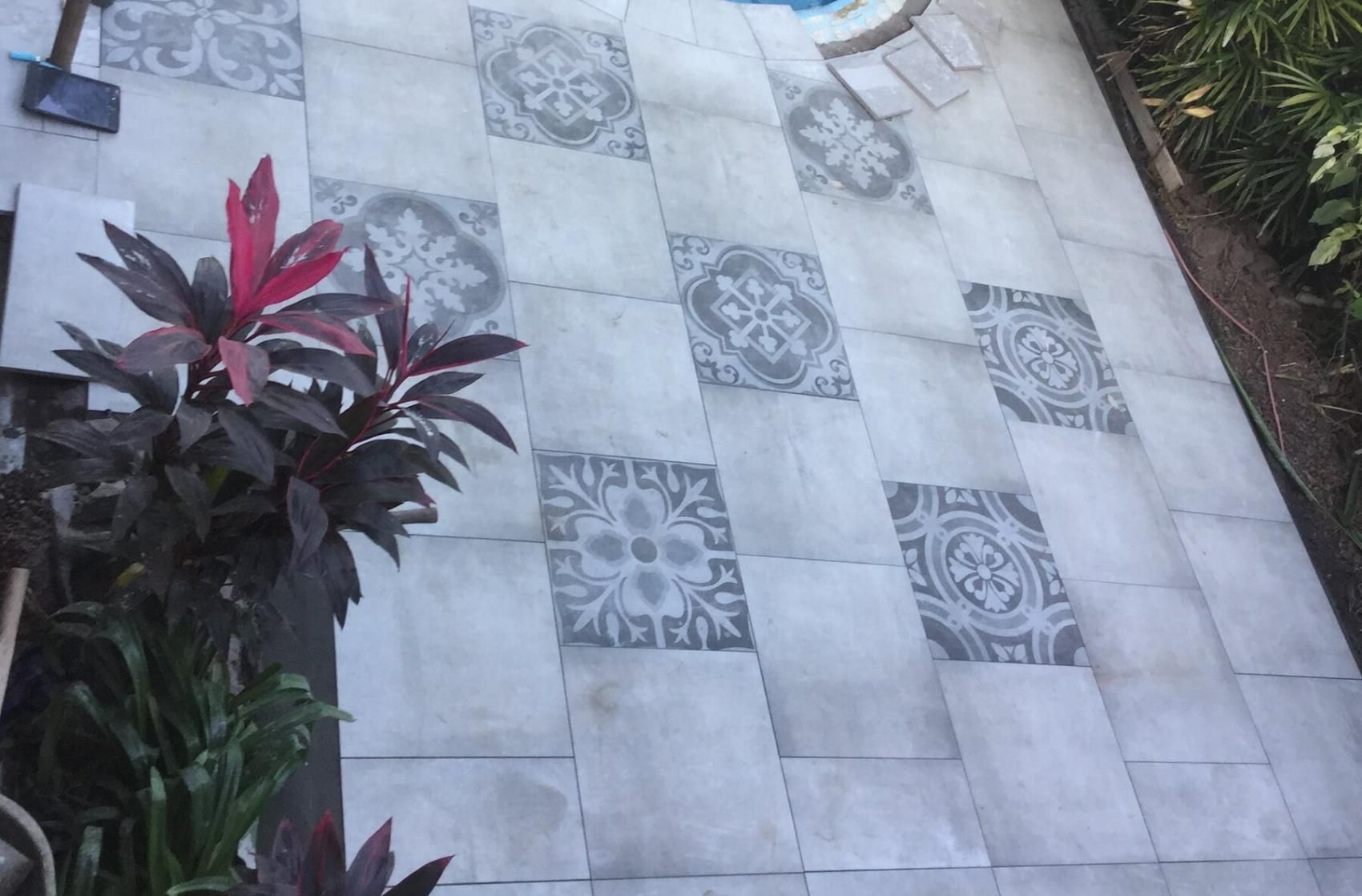 A Patio With Tiles And Plants Next To A Pool — Paving in Darwin River, NT