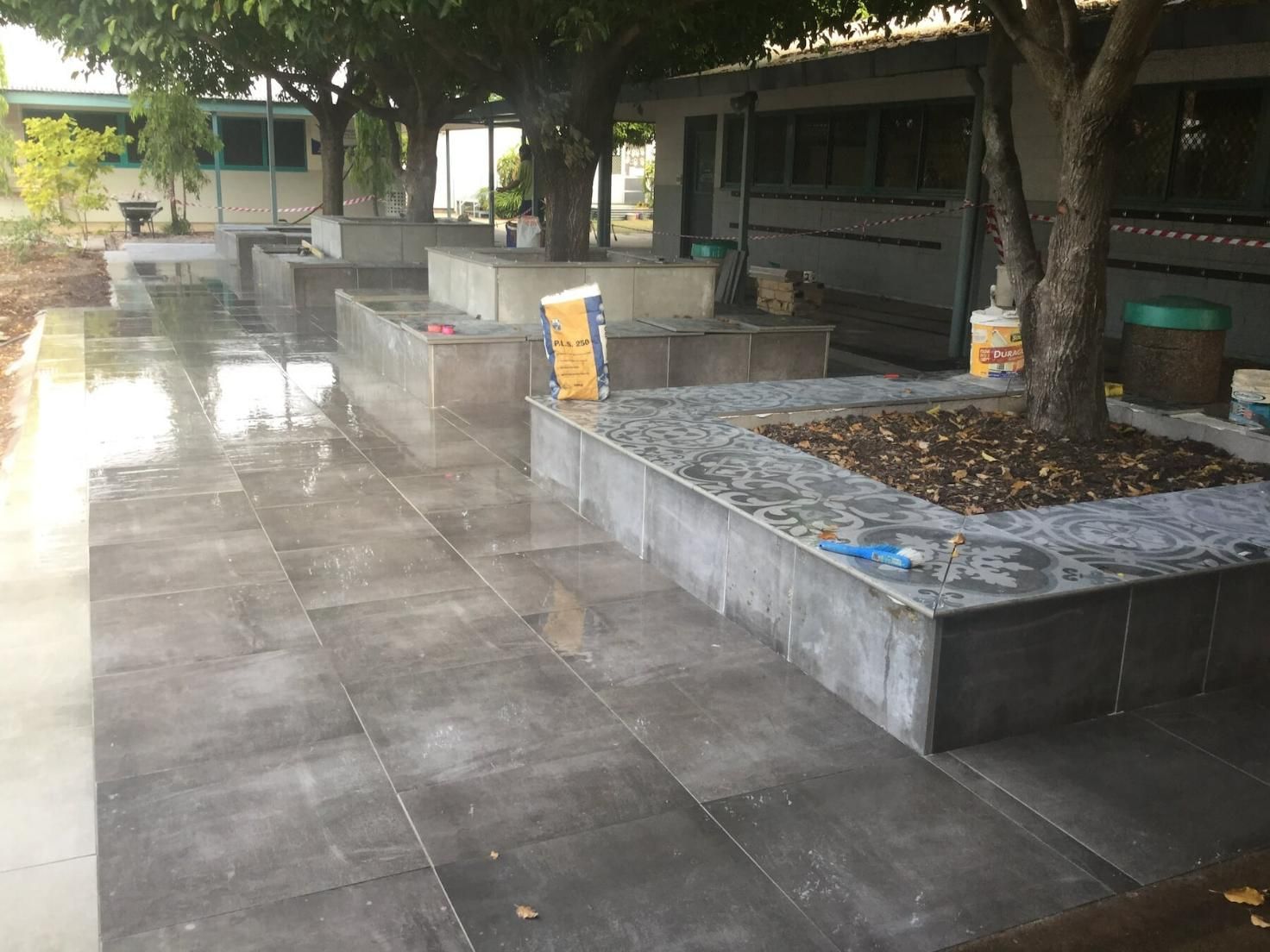 Grey Paving Tiles with Trees Planted on Right Side — Paving in Darwin River, NT