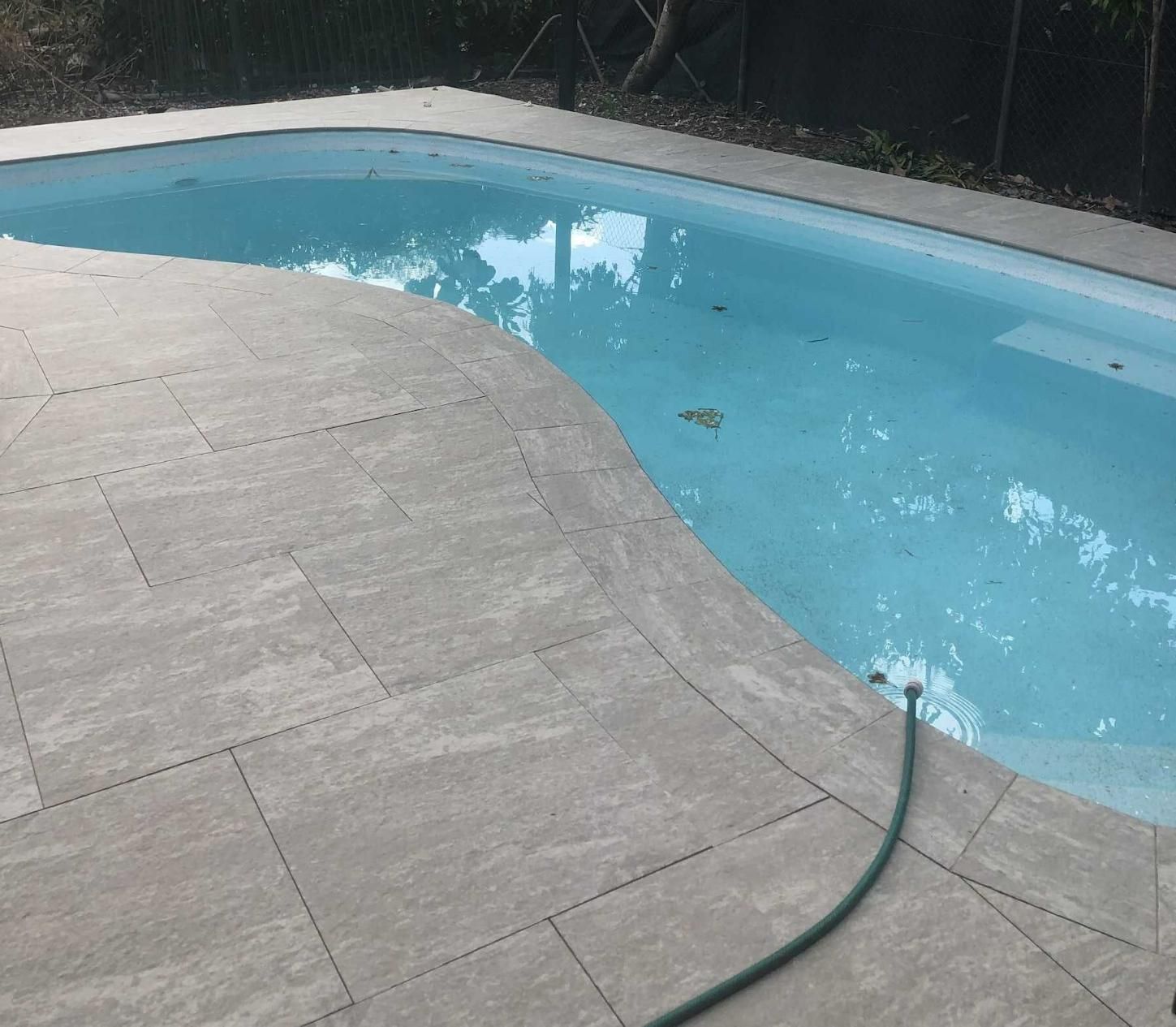Swimming Pool With Grey Paving and Unclean Water — Paving in Darwin River, NT