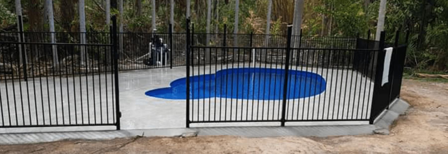 Swimming Pool With Black Fence and Clean Water in the Pool — Paving in Darwin River, NT