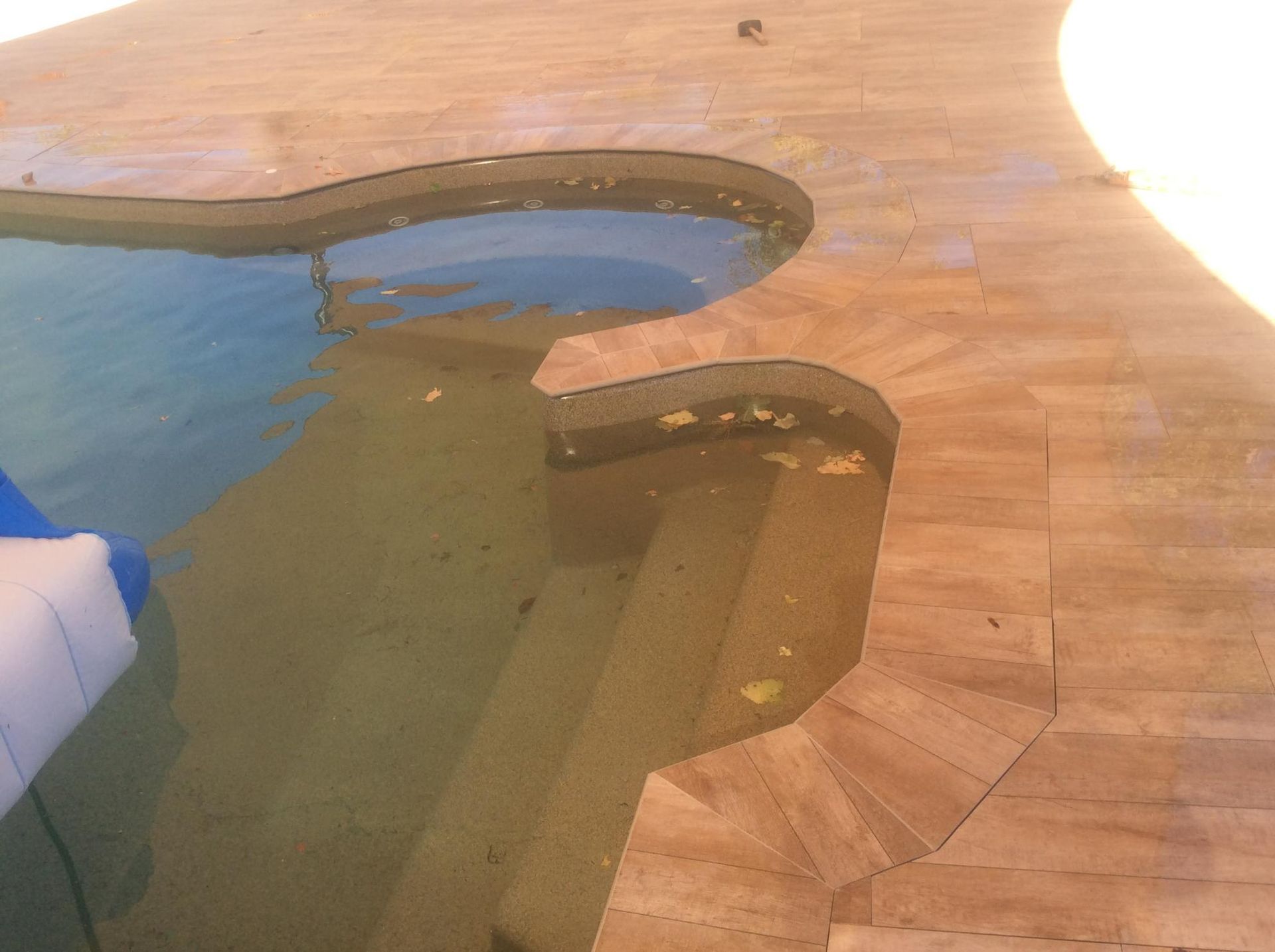 Swimming Pool With A Wooden Deck  and Unclean Water — Paving in Darwin River, NT