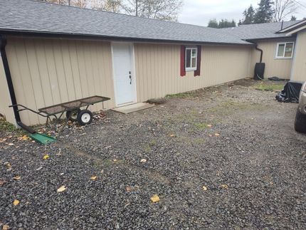 A house with a wheelbarrow in front of it