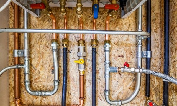 Leaking copper pipes with water dripping indoors