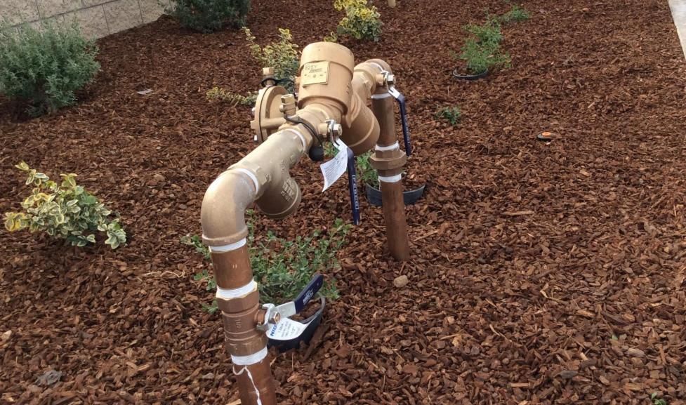 Leaking copper pipes with water dripping indoors