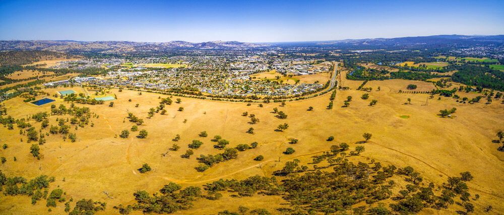 An Aerial View Of A Field With Trees And A City — Matt Walsh Plumbing in Wodonga, NSW