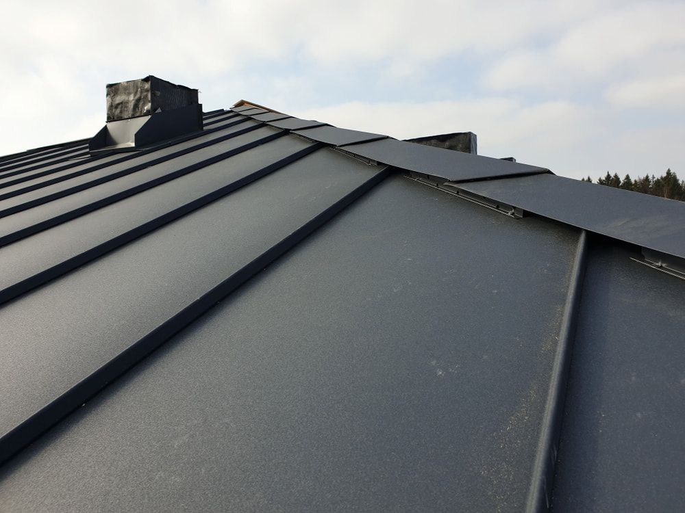 A Black Roof With A Chimney On Top Of It — Matt Walsh Plumbing in Lavington, NSW