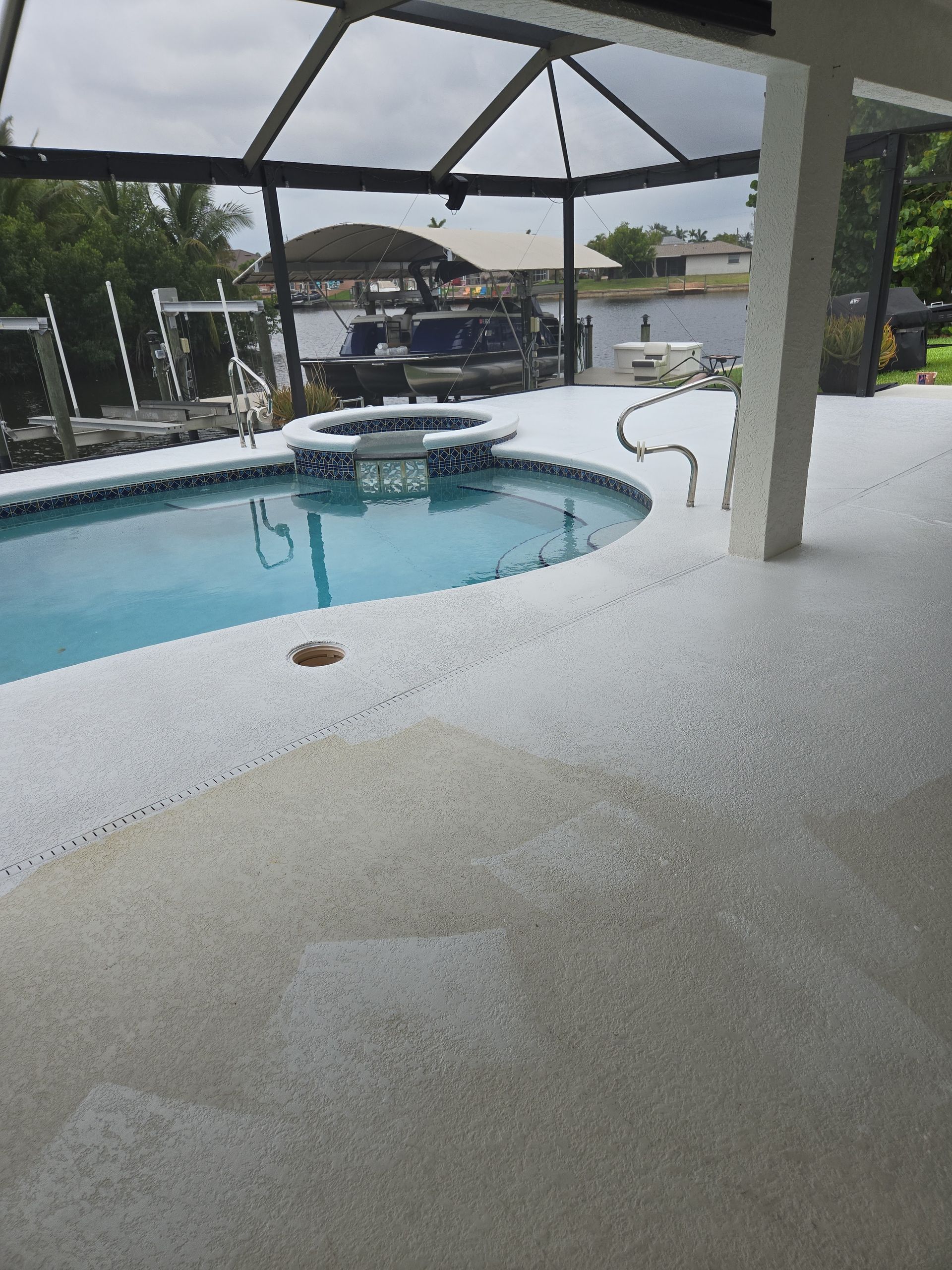 A large swimming pool with a boat in the background