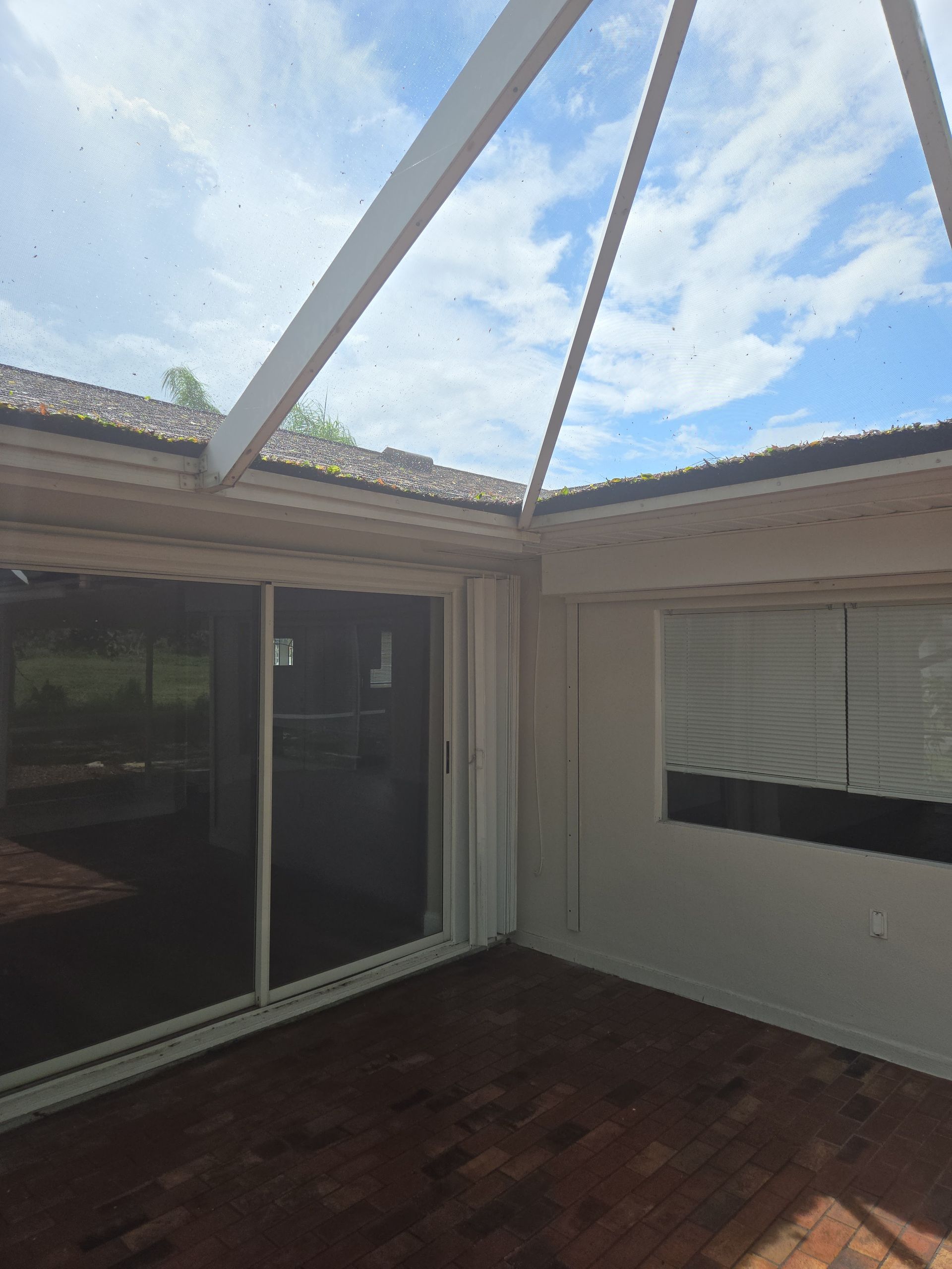 An empty room with a sliding glass door and a window