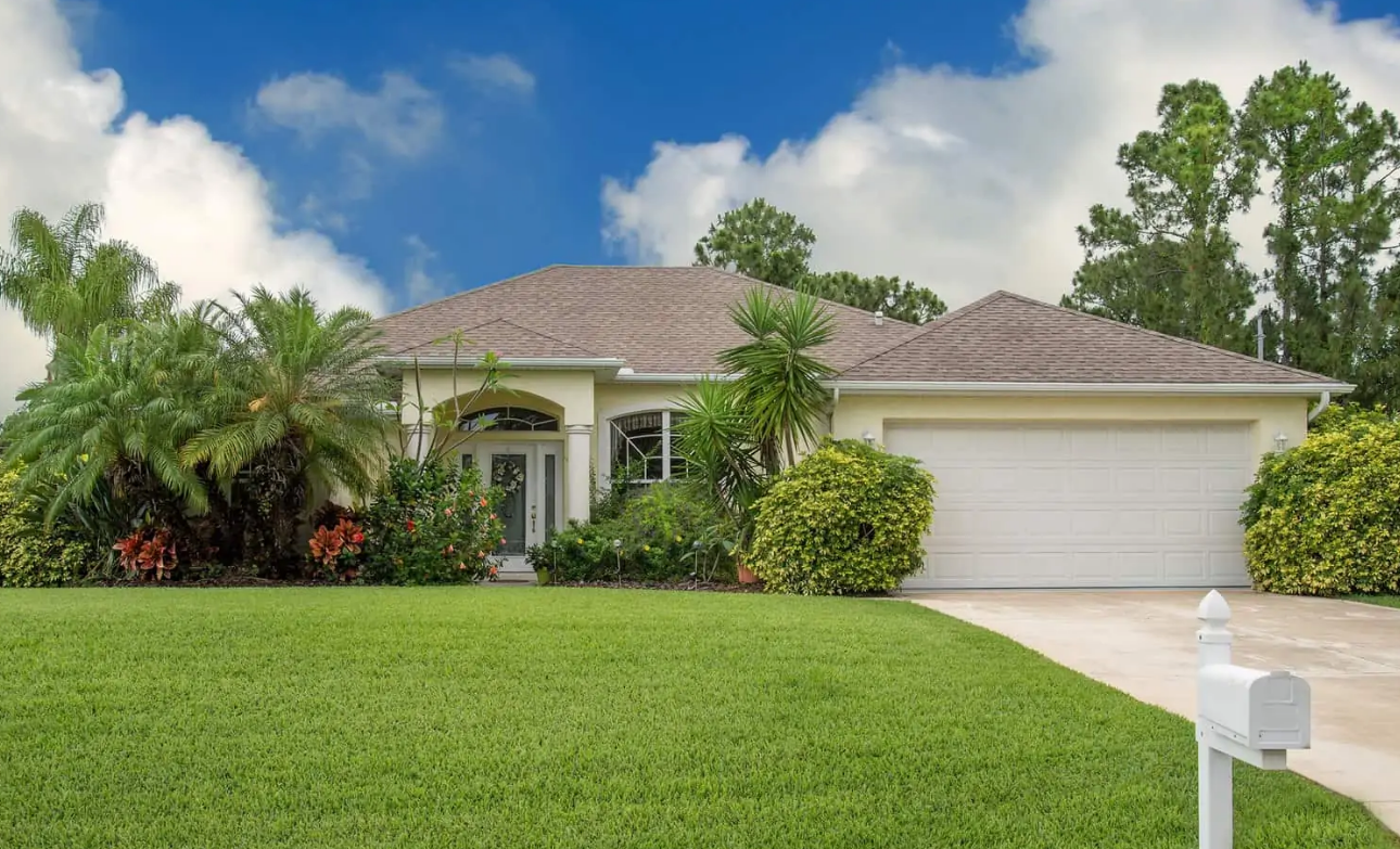 A white house with a white mailbox in front of it