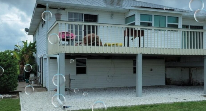 A house with a large deck and soap bubbles coming out of it