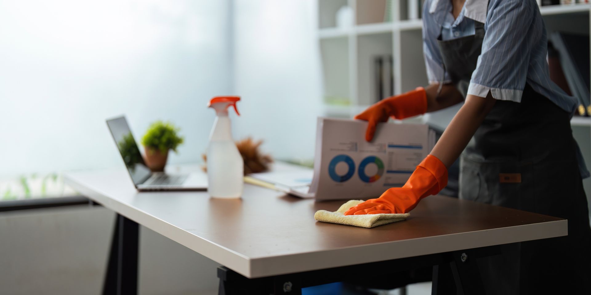 Image of a woman cleaning in an office room.
