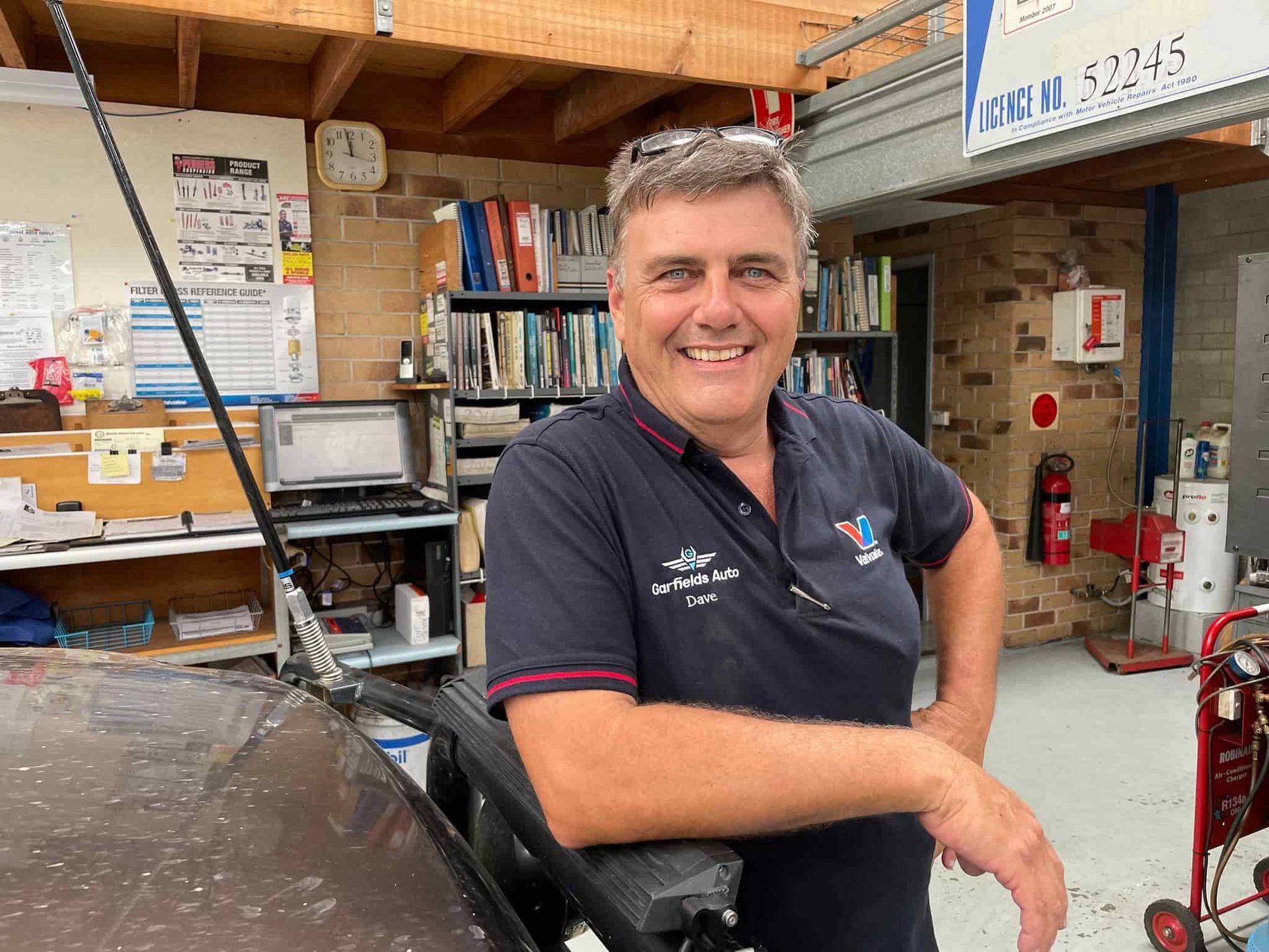 A Man is Standing in a Room With His Hands on His Hips and Smiling — Town & Country Removals In Taree, NSW