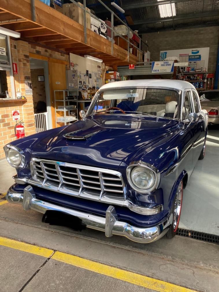 A Blue and White Car is Parked in a Garage — Town & Country Removals In Taree, NSW