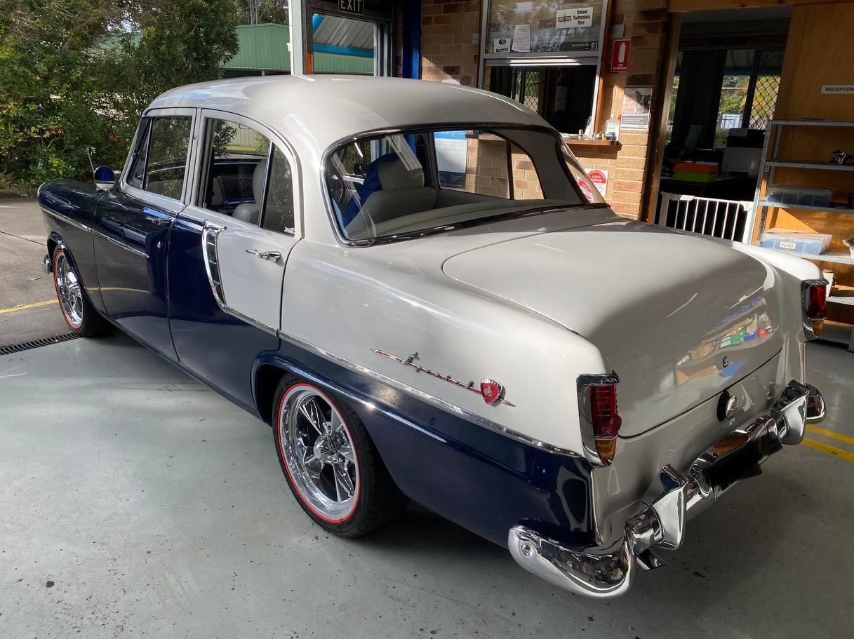 A Blue and White Car is Parked in a Garage — Town & Country Removals In Taree, NSW