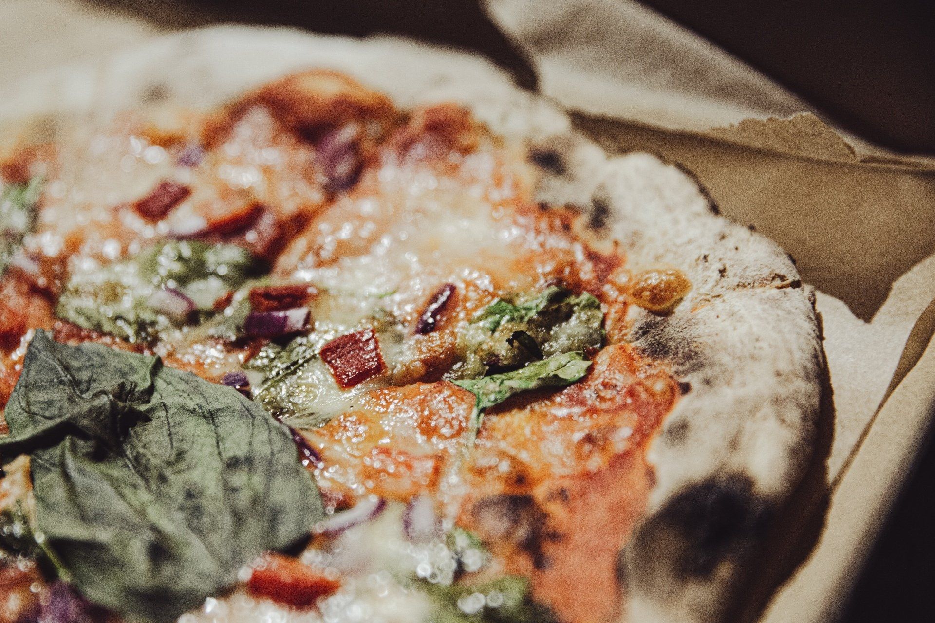 A close up of a pizza in a cardboard box.