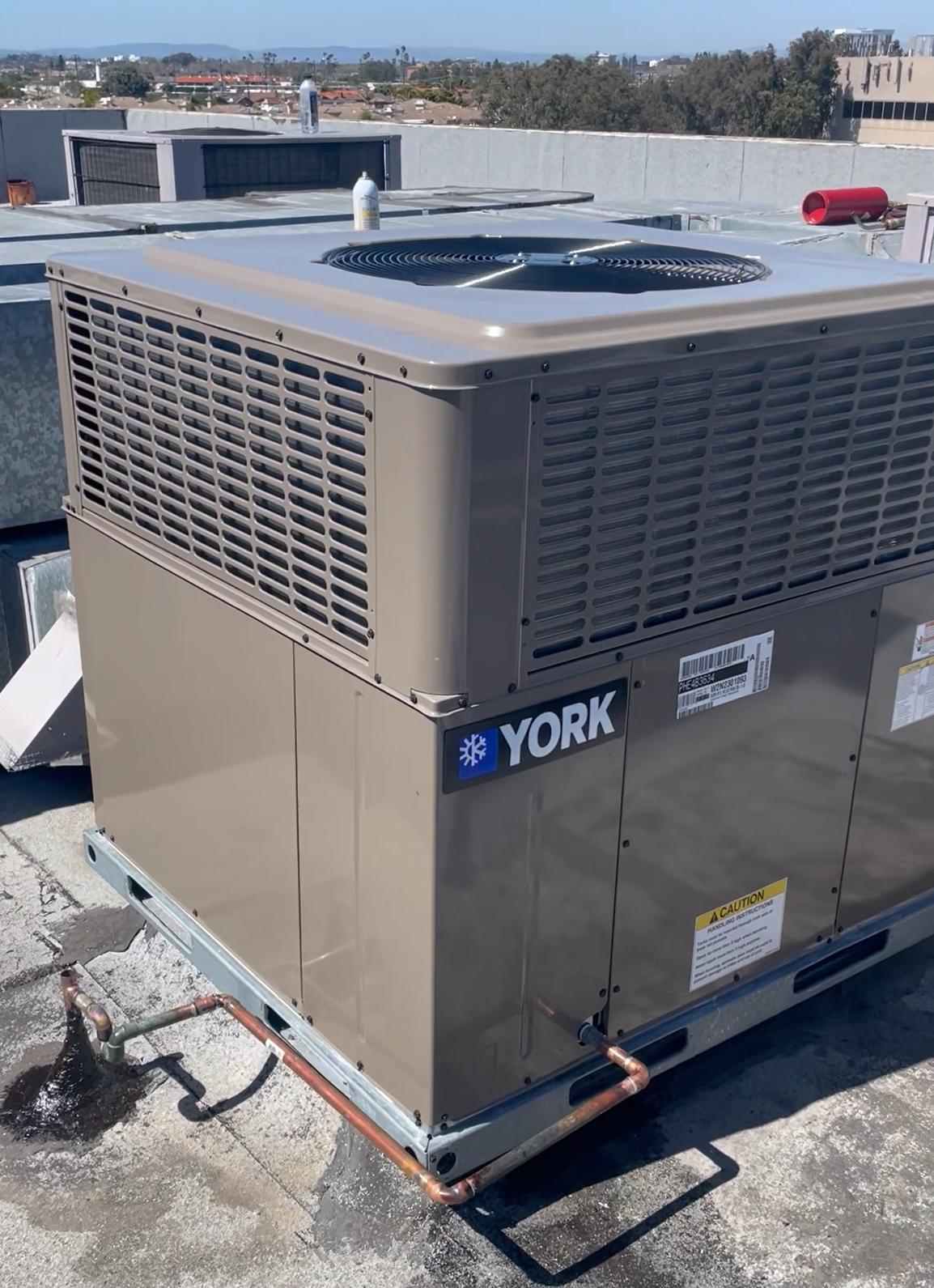 A york air conditioner is sitting on top of a roof.