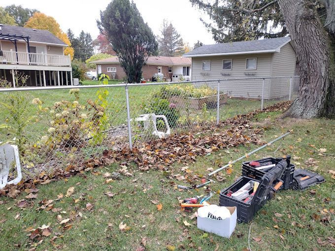A toolbox is sitting on the grass in front of a house.