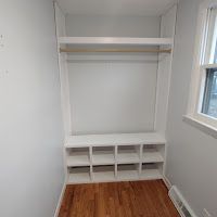 A small room with a closet and a window.