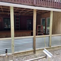 A porch is being built on the side of a house.