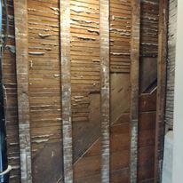 A close up of a wooden wall with a ladder in the background.