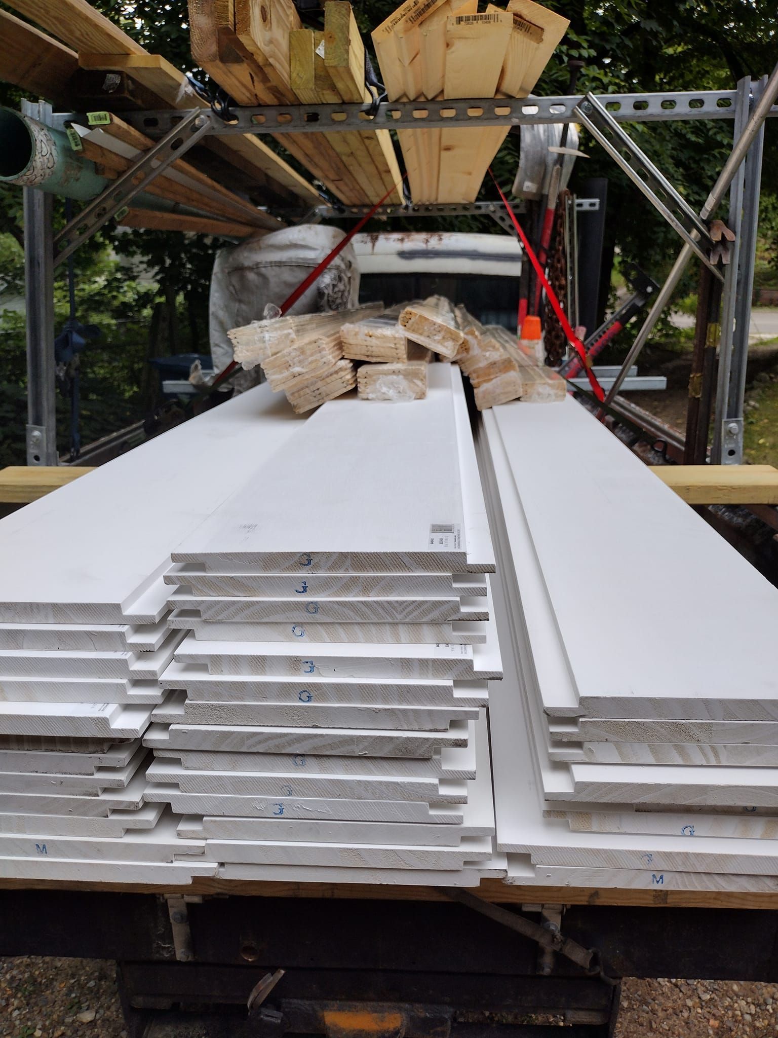 A stack of white boards is sitting on top of a wooden table.