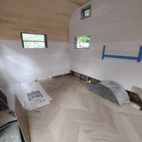 A room with a wooden floor and white walls.