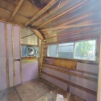 A room with a fan and a window in it.