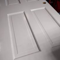 A close up of a white door with a hole in the middle.