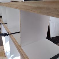 A close up of a shelf with a wooden top in a room.