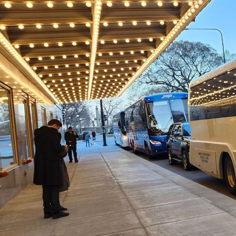Shuttle bus services A row of buses are parked under a canopy