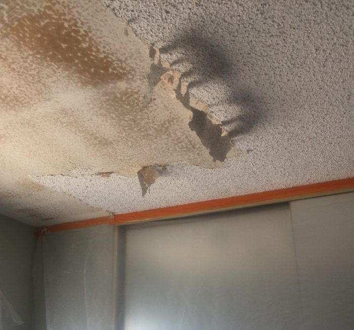 A ceiling with a shadow of a person on it