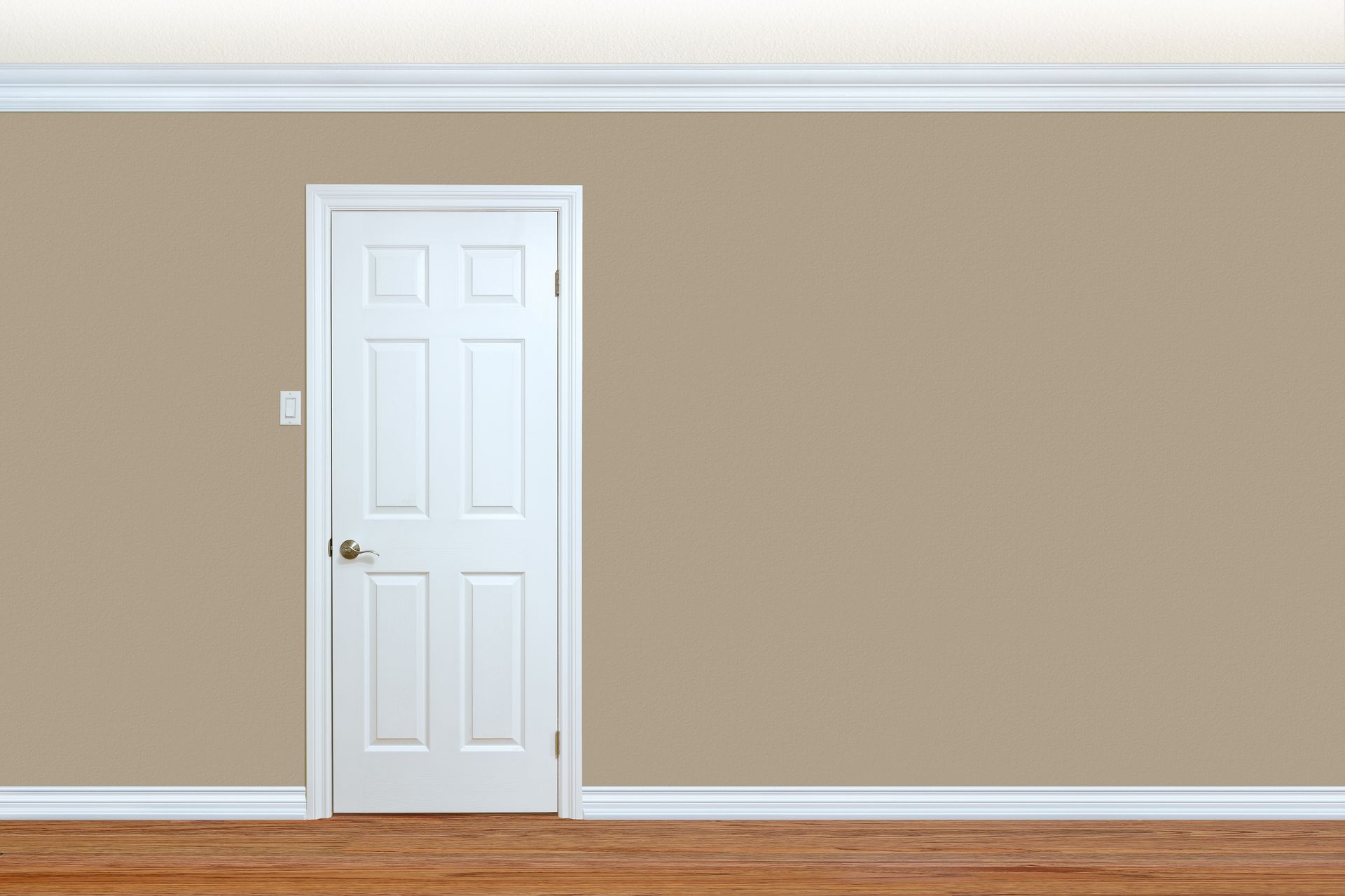 An empty room with a white door and brown walls.