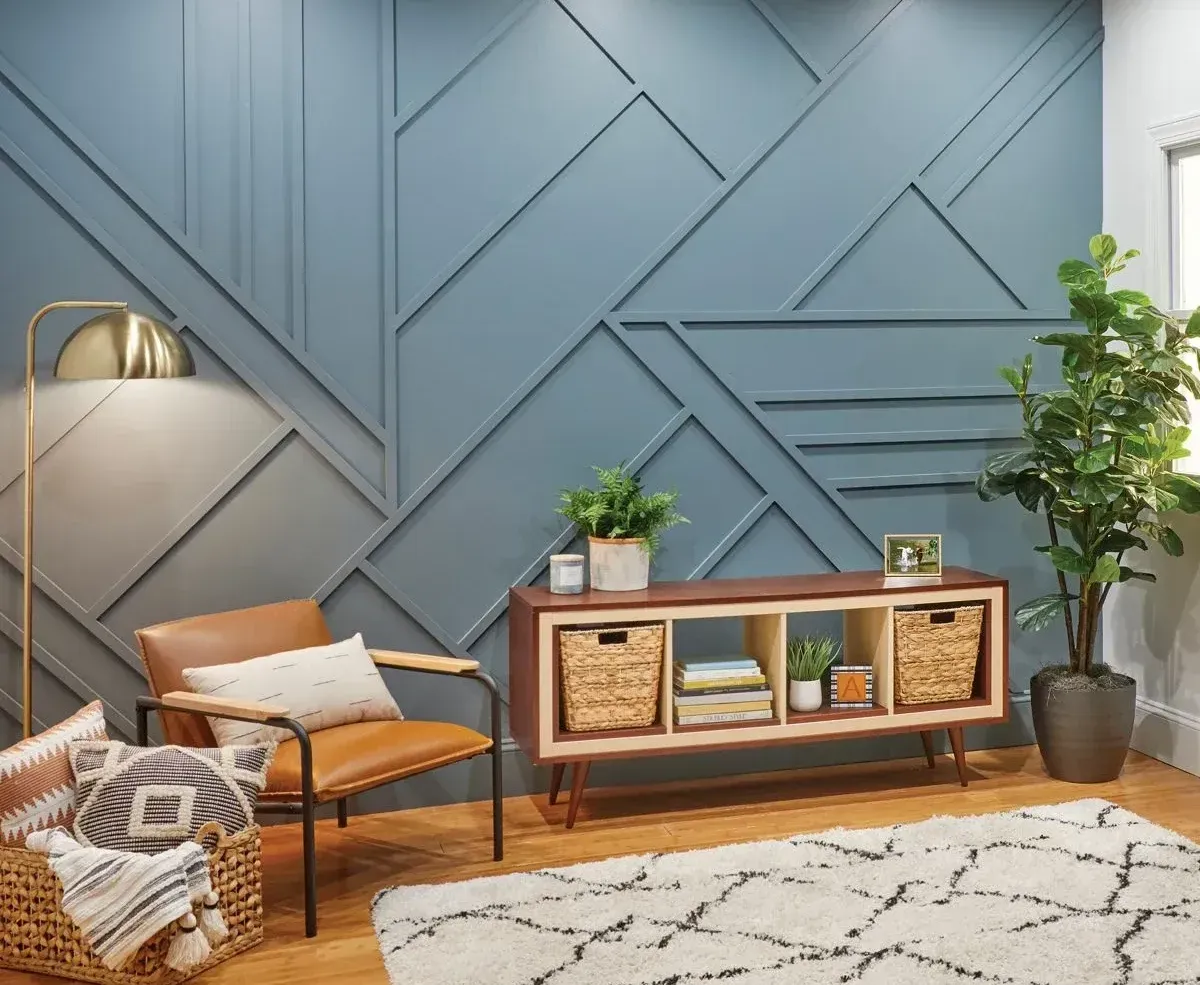 A living room with a blue wall and a brown chair