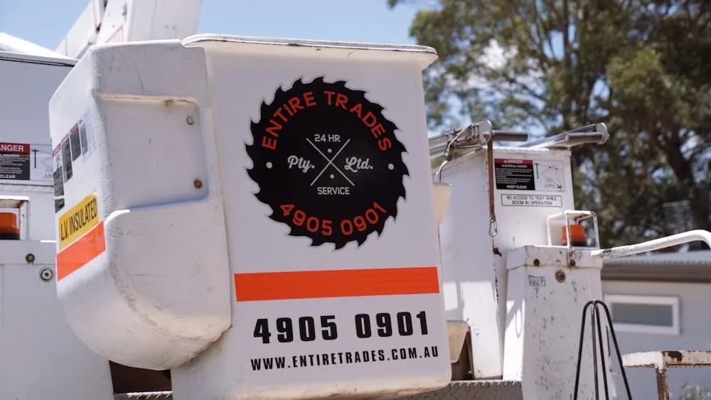 A White Truck With A Logo That Says Entire Trades — Entire Trades in Maitland, NSW