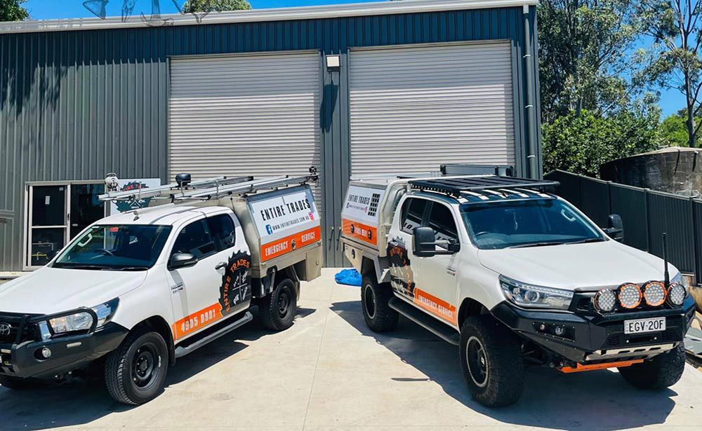 Two Entire Trades Pickup Service Vehicles In Front Of Shades — Entire Trades in Singleton, NSW