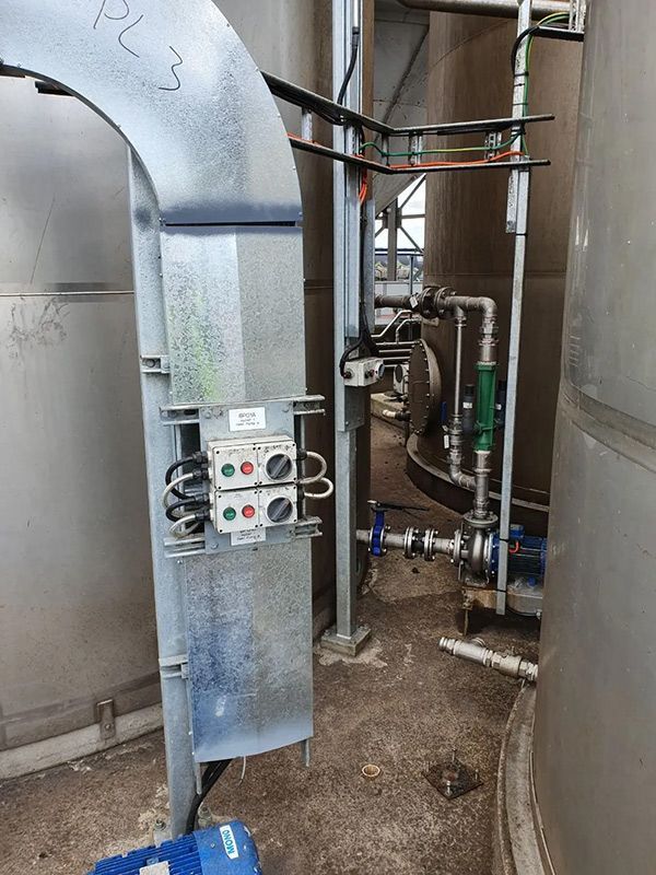 A Stainless Steel Pipe Is Connected To A Machine With Electrical Distributed Control System — Entire Trades in Cessnock, NSW