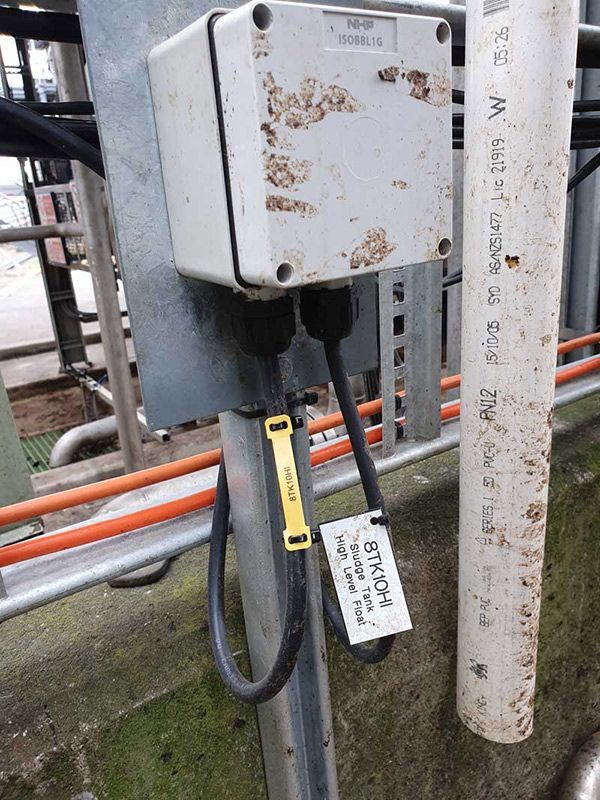 A Power Card Is Plugged Into A Box Next To A Pipe — Entire Trades in Cessnock, NSW