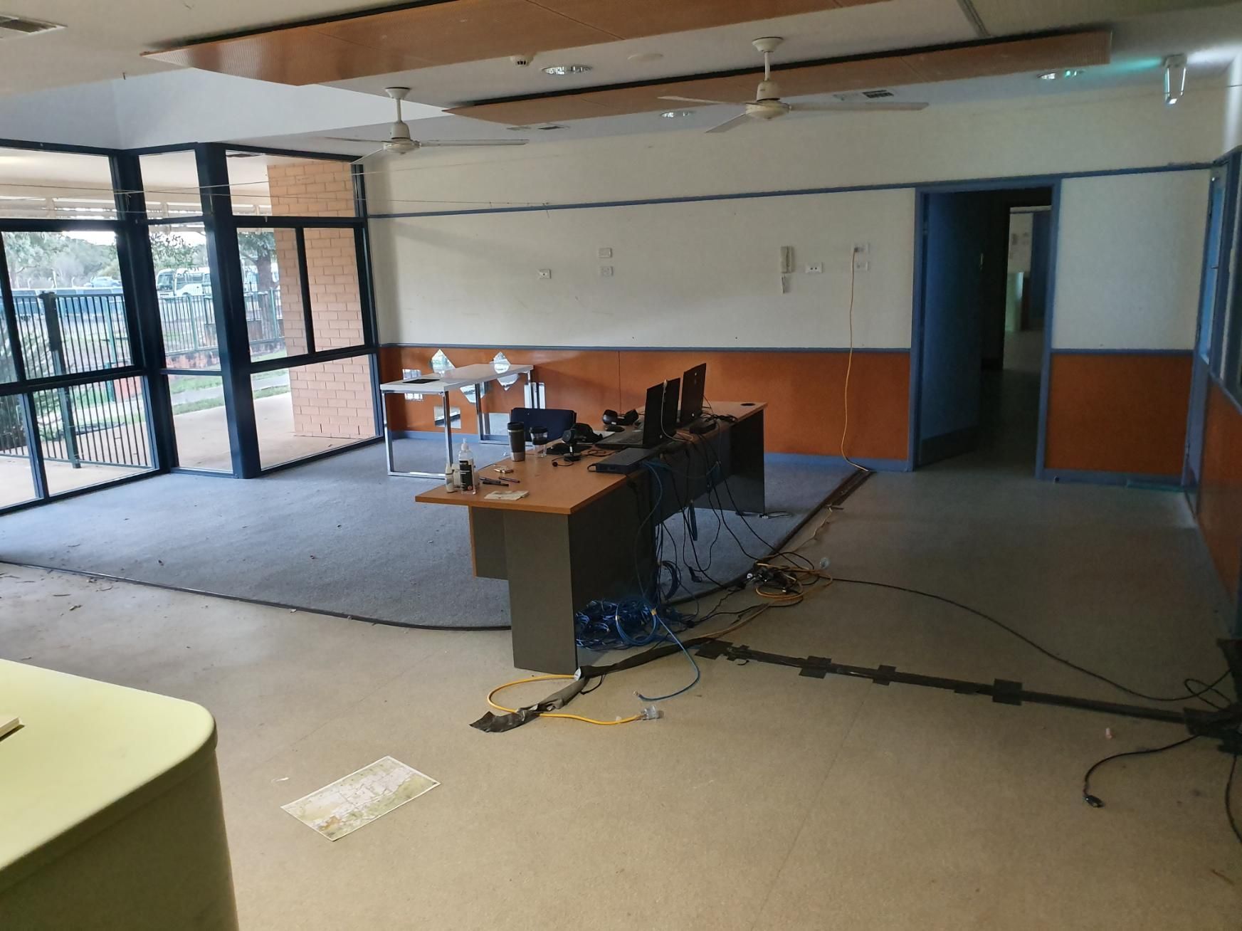 An Empty Room with A Desk and A Computer on It — Entire Trades in Maitland, NSW