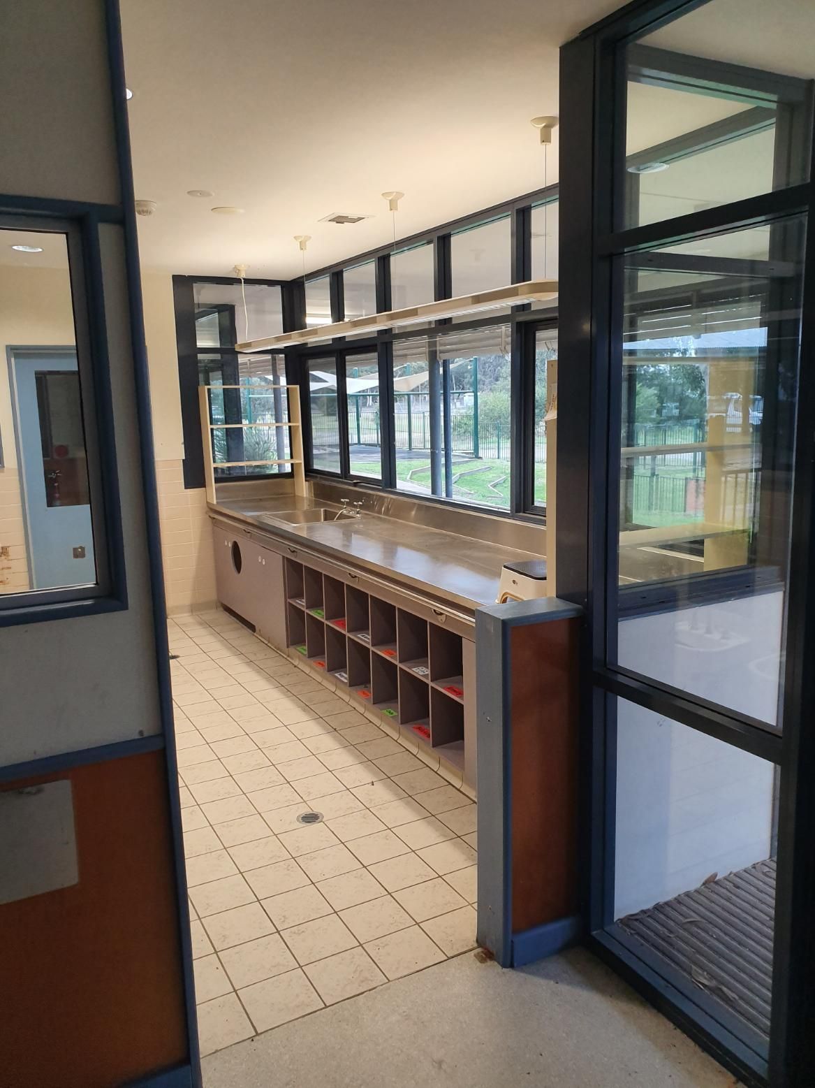 A Long Hallway with A Lot of Windows and A Counter — Entire Trades in Singleton, NSW