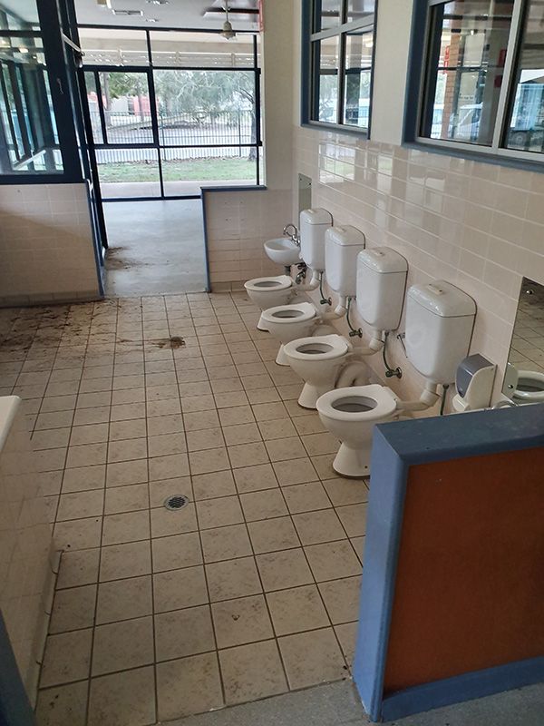 A Row Of Toilets Are Lined Up In A Bathroom Before — Entire Trades in Port Stephens, NSW