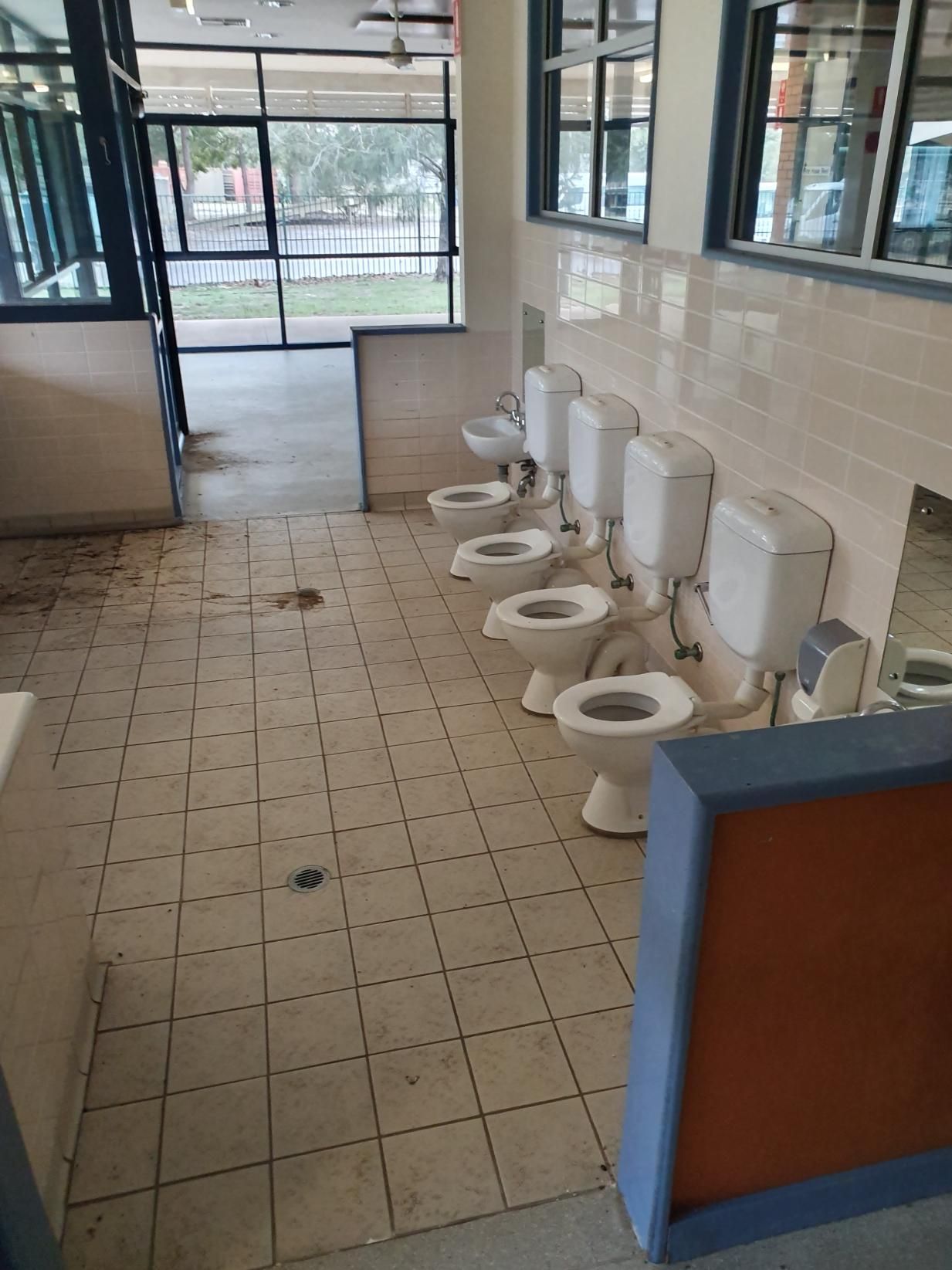 A Row of Toilets Are Lined up In a Bathroom — Entire Trades in Singleton, NSW