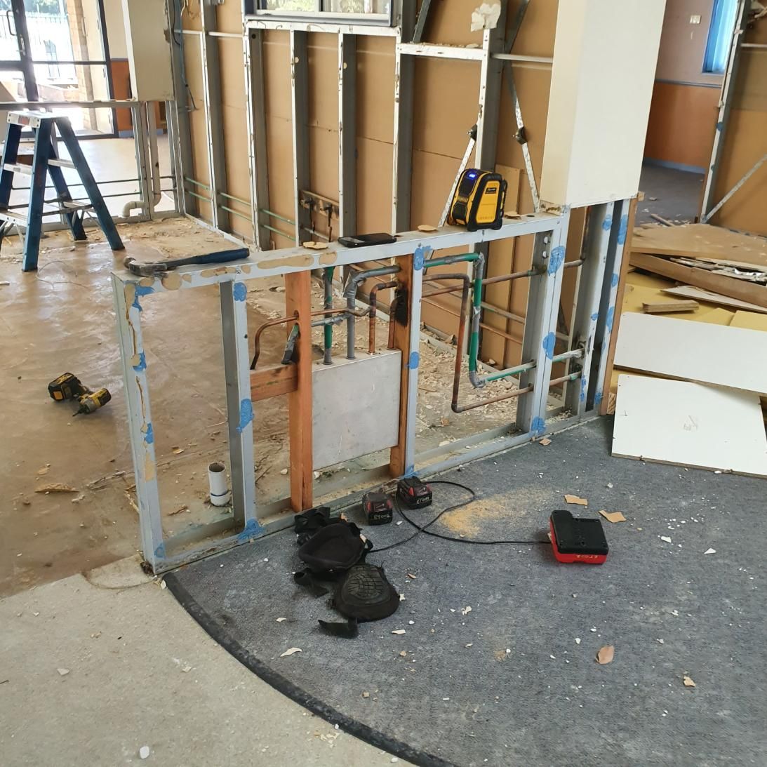 A Cat Is Laying on The Floor in A Room Under Construction — Entire Trades in Singleton, NSW